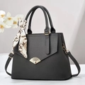 Detailed view of grey lychee leather tote with gold shell buckle and silk scarf handle - 30x12x23cm / Gray