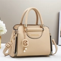 Dettaglio borsa beige in pelle a grana di litchi con ciondolo dorato a stella e luna e perla - Cachi