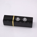 Transparent silicone earring backs displayed on a black and gold lipstick case - Clear Conical Silicone Earring Plugs