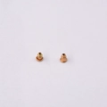 Macro shot of rose gold bullet clutch earring backs showing metallic texture and structure - Rose Gold Bullet Metal Earring Backs
