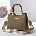 Detail of canvas bag with woven texture, resin round handles, and patterned wide strap - Khaki