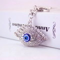 Portachiavi con malocchio blu scintillante, moschettone in argento e strass lucidi - Argento