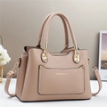 Dettaglio della borsa a tracolla in pelle beige con finiture dorate e doppi manici - Albicocca