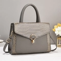 Detail of grey crocodile texture tote bag with gold ring lock and side pocket design - Gray
