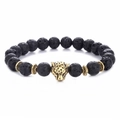 Black lava stone bracelet with golden leopard head and patterned beads on white background - Gold