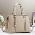 Close-up of beige leather handbag texture with gold star and moon pearl pendant decoration - Khaki