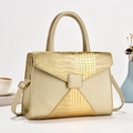 Detail of light gold crossbody bag with crocodile and lychee leather textures - Gold