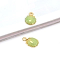 Detail view of light green shell pendants with gold trim for DIY jewelry making - Green Shell