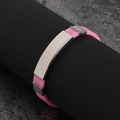 Pink silicone sports bracelet with silver metal plate on cylindrical display stand - Pink