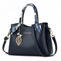 Navy blue lychee leather handbag with decorative scarf and golden leaf charm accessory - Blue