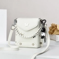 White PU leather mini crossbody bag with silver butterfly accent and bear charm decoration - Off-white