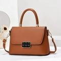 Minimalist caramel leather crossbody handbag with magnetic buckle on minimalist white display - L24cm x W8cm x H16cm / Earthy Yellow