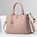 Dusty rose leather handbag with lychee texture and V-shaped gold hardware detail - Pink
