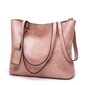 Close-up of pink faux leather tote bag showing rich PU texture and dual handles - Pink
