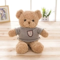 Brown curly plush teddy bear wearing a grey knitted sweater with crest embroidery - Tan / 30cm