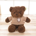 Brown teddy bear plush toy wearing a beige knitted sweater on a light wood background - Coffee / 70cm