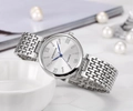 Detail of silver ladies quartz watch with blue hands and crystal markers on white ceramic - Silver White Face