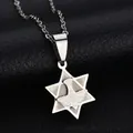 Macro shot of silver stainless steel Star of David pendant with peace dove on black leather - Silver Hexagram Dove