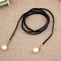 Elegant black woven waist chain for women featuring white pearls and gold metal accents - Black