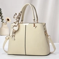 Close-up of beige lychee texture handbag with silk scarf and golden metal hardware - Off-white