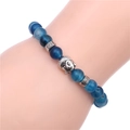 8mm blue agate bead bracelet with silver Buddha head charm on a wrist model - Blue