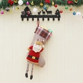 Hanging Christmas stocking with long legs, plaid cuff, and plush Santa doll decoration - Santa Claus