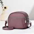 Detail of mauve crossbody bag with triple zippers and lychee grain leather texture - Purple