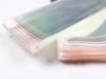 Macro detail of transparent plastic self-sealing bags with red seal strip for packaging - Female Socks Self-Adhesive Packaging Bag