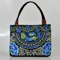 Ethnic black canvas handbag with vibrant blue floral embroidery and wooden beads - Apple Blossom Blue