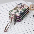 Beige canvas wristlet clutch with colorful bicycle print and three zipper compartments - Bicycle