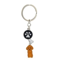 Macro shot of silver metal keyring with paw print, bone charms, and brown poodle pendant - Brown Poodle