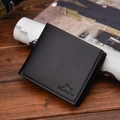 Minimalist black leather bi-fold wallet for men with lychee texture on wooden surface - Horizontal Black