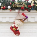 Calza di Natale premium con Babbo Natale 3D appesa su decorazioni per il camino - Babbo Natale
