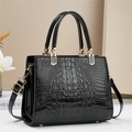 Elegant black crocodile pattern leather handbag with gold hardware and shoulder strap - Black