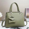 Detail of sage green pebble leather handbag with matching mini coin purse and silver hardware - Rock Green