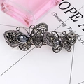 Close-up of vintage silver butterfly hair clip with grey gemstones and purple rhinestones - Double Butterfly Joint - Purple