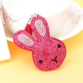 Macro shot of dark pink rhinestone rabbit keychain with matching tassel and metal hook - Rose Red