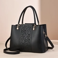 Chic black tote bag with vintage cloud embroidery and elegant gold hardware accents - Black