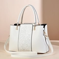 Elegant white crossbody handbag featuring embossed cloud patterns and pearl handle detail - White