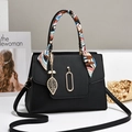 Elegant black lychee leather handbag with silk scarf handle and golden leaf charm - Black