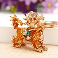 Golden Kirin car keychain with rhinestones and colorful enamel on a white background - Yellow Lucky Kylin