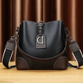 Chic black and brown color-block bucket bag with wide strap and metallic D pendant - Black