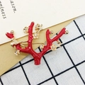 Red enamel coral brooch with gold flower accents and crystals on a plaid background - 414 Red Christmas Tree