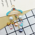 Christmas blue coat hanger brooch with festive reindeer, snowman and candy cane charms - 140 Gift Hanger Charms