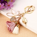 Floral keychain with white enamel flower, pink fabric rose, and gold tassel charms - Pink White Metal Tassel Flower