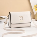 Elegant beige PU leather crossbody bag featuring golden reindeer horn metal hardware - White