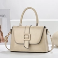Detail of beige leather texture on elegant handbag with square buckle and adjustable strap - Khaki