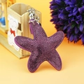 Detail of purple starfish bag charm with rhinestones, silver clasp and suede tassel - Silver Purple