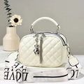 Elegant white quilted crossbody bag with bear charm and LOVE printed shoulder strap - Off-white