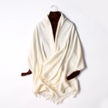 Cream white knitted tassel shawl draped over a dark brown turtleneck sweater - Milk White